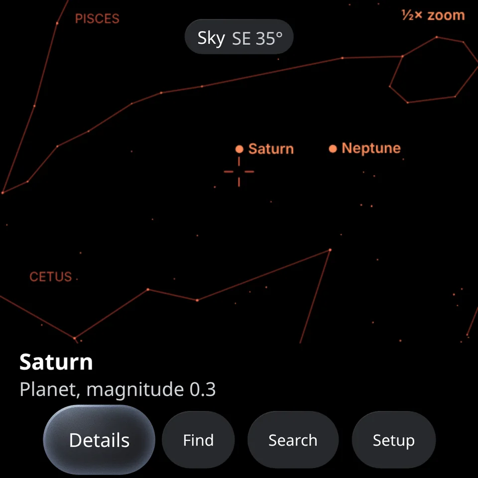 Starry Eyes on the glasses display: constellation lines for Pisces and Cetus, with Saturn and Neptune labelled. The card at the bottom reads Saturn, planet, magnitude 0.3.
